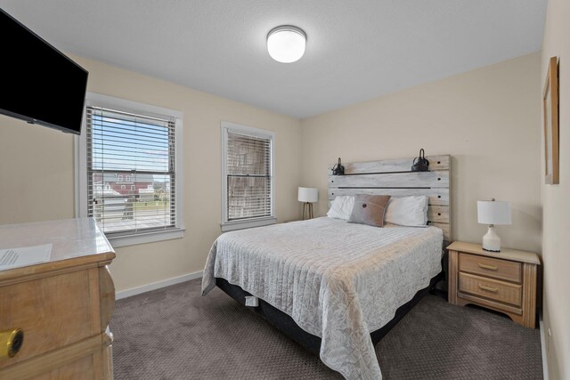 carpeted bedroom with baseboards