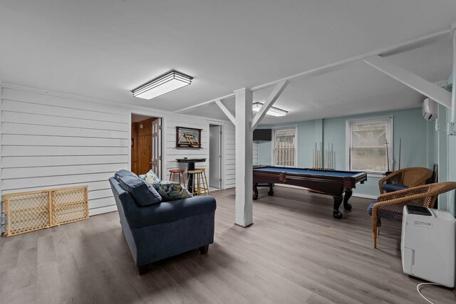 game room with pool table, a wall unit AC, and wood finished floors