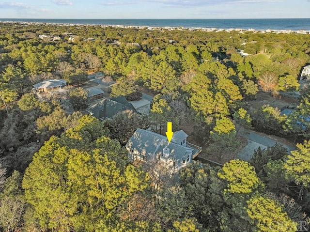 drone / aerial view featuring a water view and a view of trees