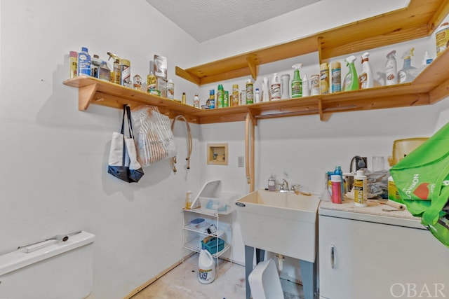 laundry area with washer hookup, laundry area, and a textured ceiling