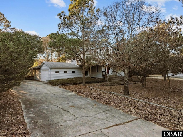 view of front of property featuring an outbuilding, driveway, and an attached garage