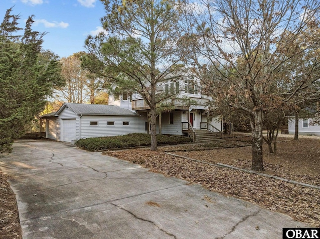 view of front of property featuring a garage and an outdoor structure