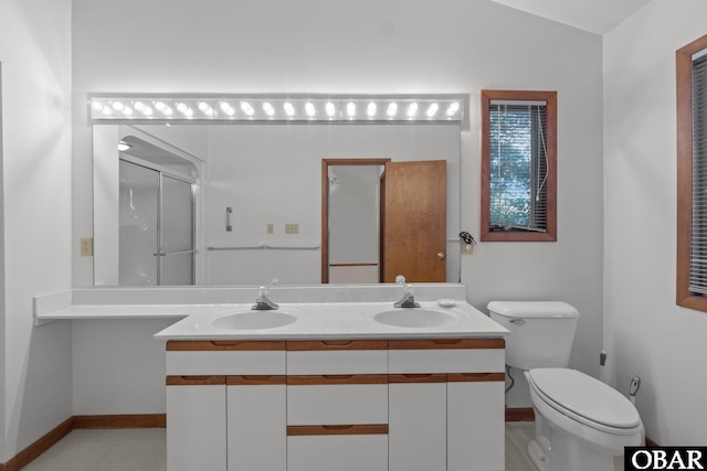 bathroom with a stall shower, lofted ceiling, a sink, and double vanity