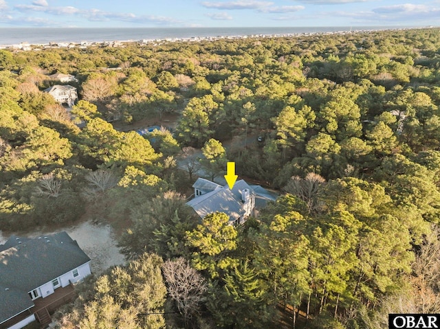 aerial view featuring a water view and a wooded view