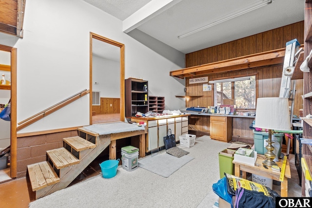 misc room with wooden walls, visible vents, a workshop area, and wainscoting