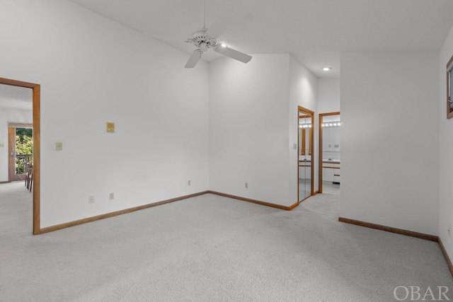 spare room featuring baseboards, light colored carpet, ceiling fan, high vaulted ceiling, and recessed lighting