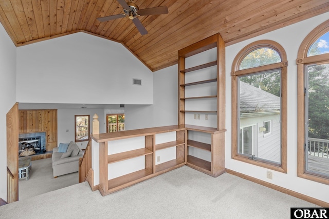 living area featuring visible vents, baseboards, light colored carpet, wood ceiling, and a fireplace