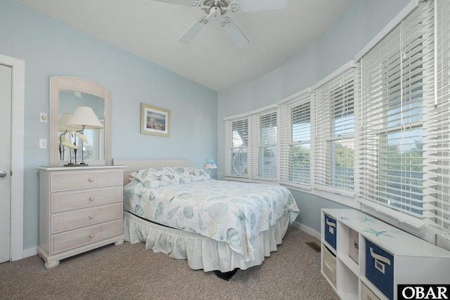 bedroom featuring baseboards, multiple windows, carpet, and a ceiling fan