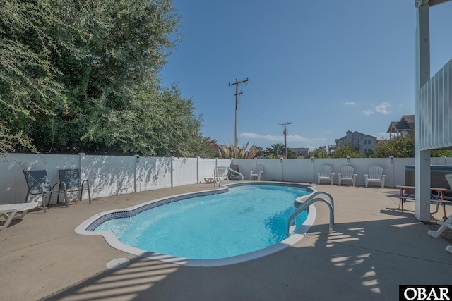 view of swimming pool featuring a patio, a fenced in pool, and a fenced backyard