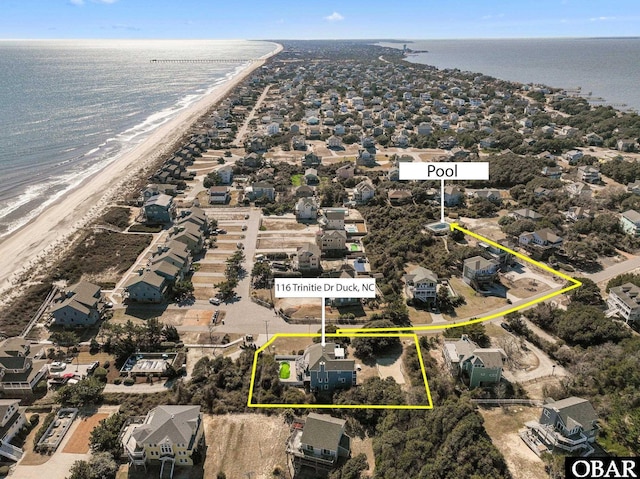 drone / aerial view featuring a water view and a beach view