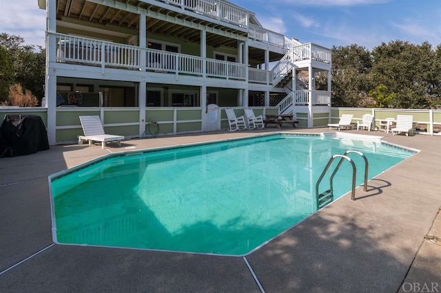 pool with a patio area and area for grilling