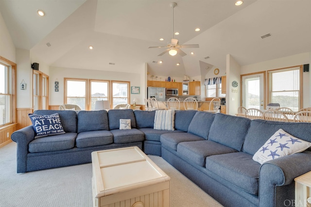 living room featuring recessed lighting, a wainscoted wall, light colored carpet, visible vents, and vaulted ceiling