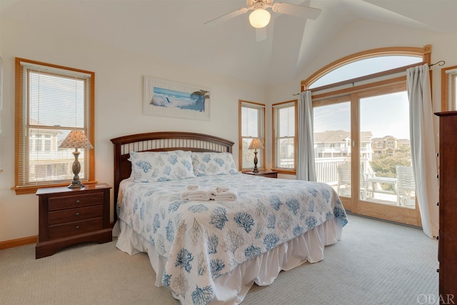 bedroom featuring access to exterior, light carpet, and multiple windows