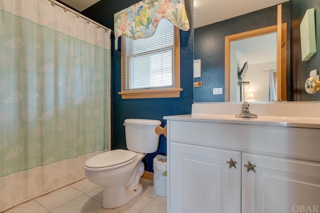 bathroom featuring vanity, toilet, and tile patterned floors