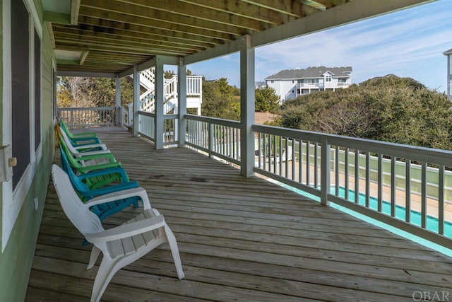 wooden deck featuring an outdoor pool