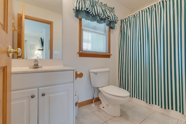 bathroom with baseboards, toilet, a shower with curtain, tile patterned floors, and vanity