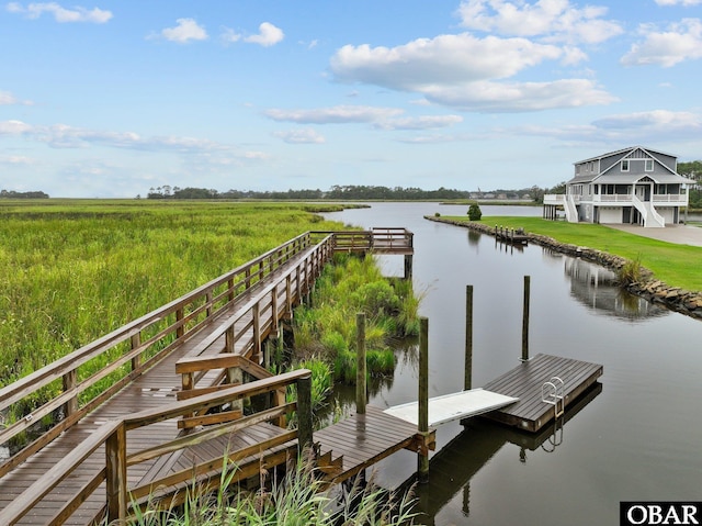 view of dock featuring a water view and a rural view