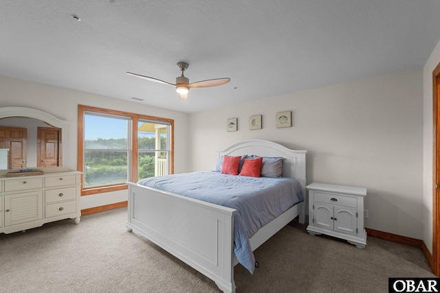 carpeted bedroom featuring ceiling fan, visible vents, and baseboards