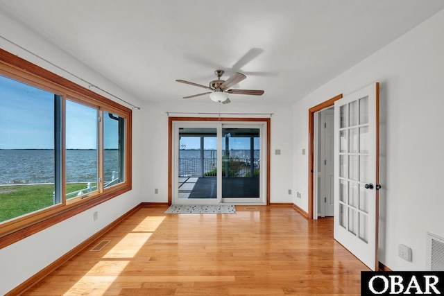 interior space with a water view and visible vents