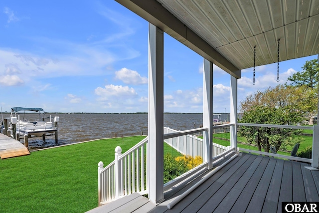 wooden terrace featuring a yard, a water view, a boat dock, and boat lift
