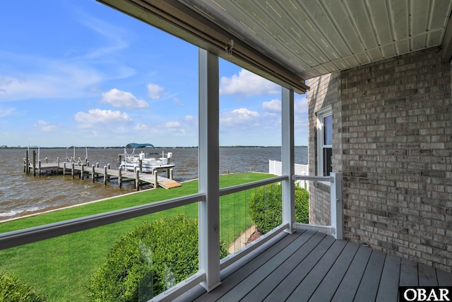 wooden terrace featuring a boat dock and a water view