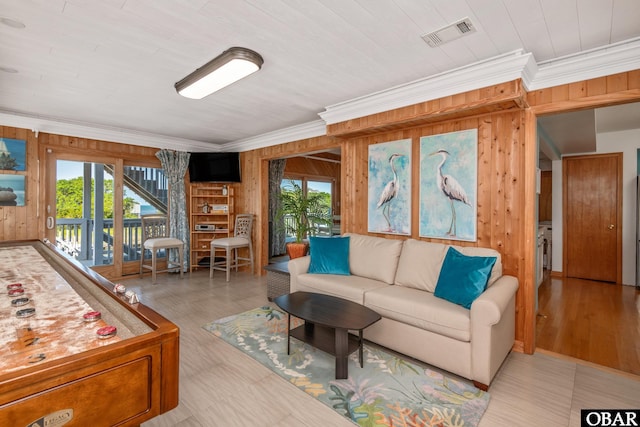 50011 Kings Point Dr Lot 335, Frisco, NC 27936 - living area featuring wooden walls, visible vents, a wealth of natural light, and crown molding