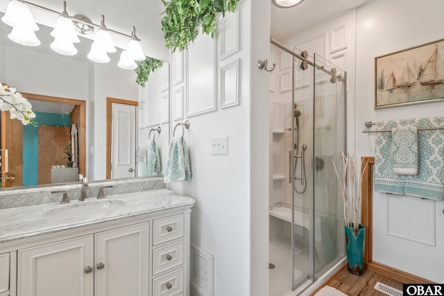 50011 Kings Point Dr Lot 335, Frisco, NC 27936 - bathroom with a shower stall, visible vents, vanity, and wood finished floors