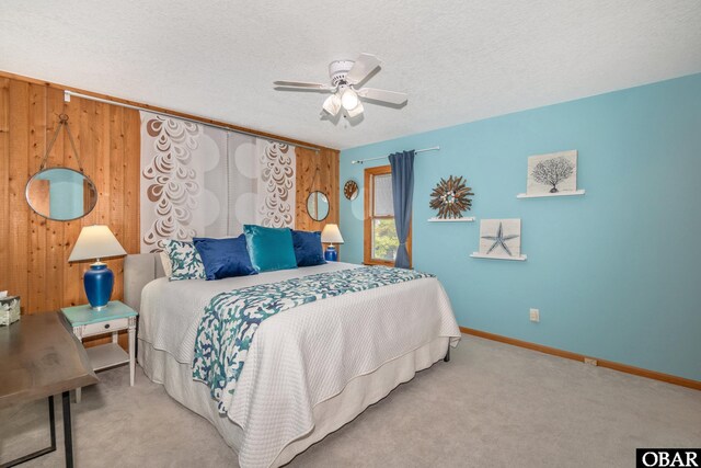 50011 Kings Point Dr Lot 335, Frisco, NC 27936 - carpeted bedroom featuring wooden walls, a textured ceiling, baseboards, and ceiling fan