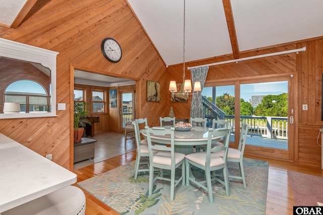 50011 Kings Point Dr Lot 335, Frisco, NC 27936 - dining space with a chandelier, a healthy amount of sunlight, and wood walls
