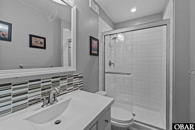 bathroom with tasteful backsplash, visible vents, toilet, vanity, and a shower stall