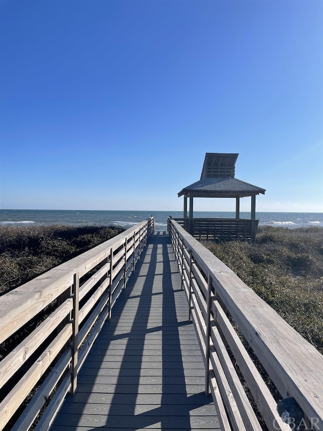 view of dock featuring a water view and a gazebo