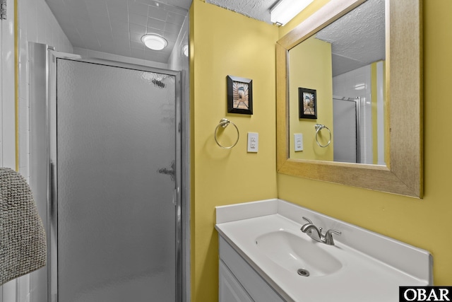 full bathroom with a shower stall and vanity