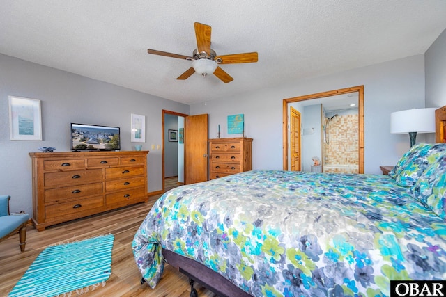 bedroom featuring light wood-style floors, a ceiling fan, and a textured ceiling