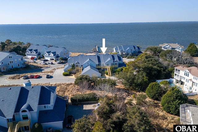 drone / aerial view featuring a residential view and a water view