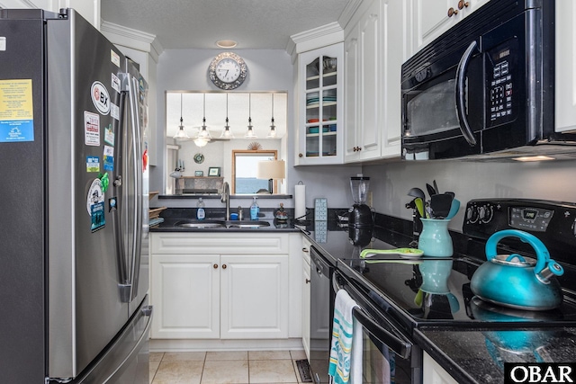 kitchen featuring glass insert cabinets, white cabinets, a sink, and black appliances