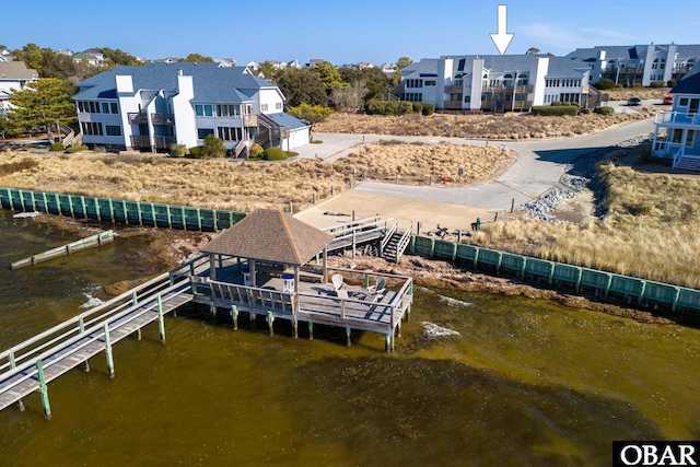 dock area with a water view and a residential view