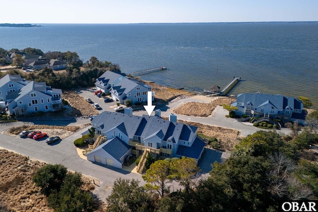 drone / aerial view with a water view and a residential view