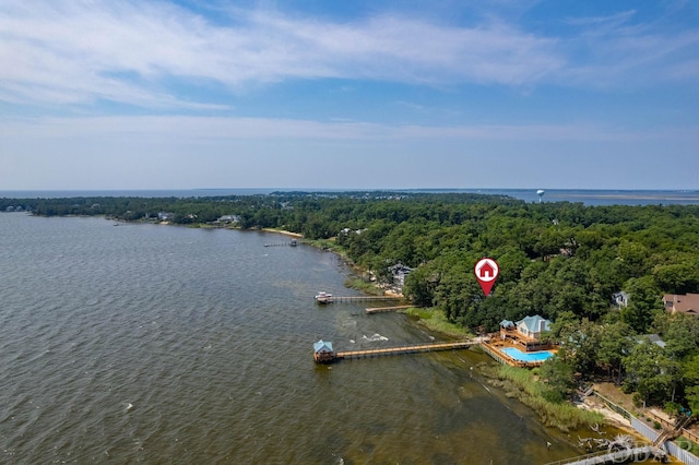 aerial view with a water view and a wooded view