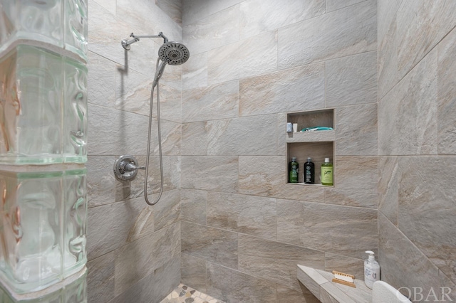 full bath with tiled shower