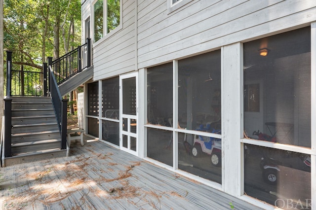 wooden terrace with stairs and a sunroom