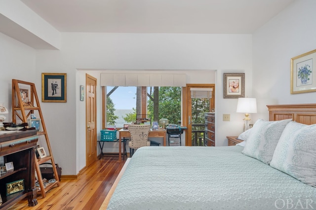 bedroom featuring baseboards and wood finished floors