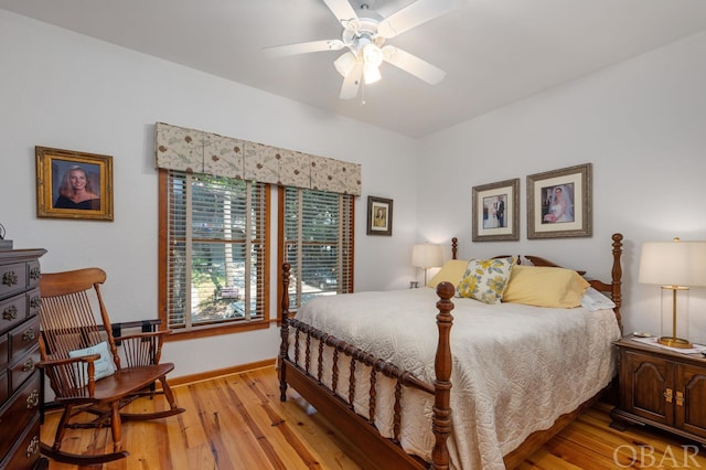 bedroom featuring light wood finished floors and baseboards