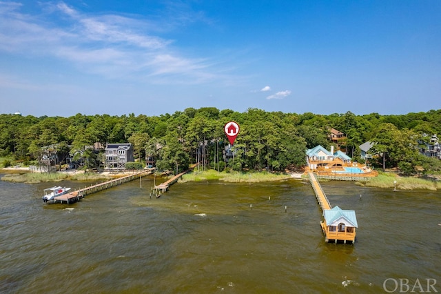 view of dock featuring a water view and a forest view