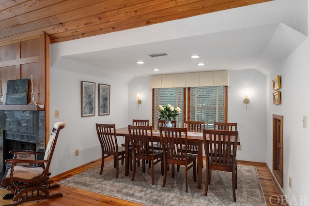 dining space with recessed lighting, a fireplace, wood finished floors, visible vents, and baseboards