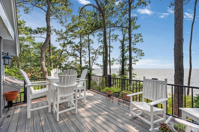 wooden terrace featuring a water view