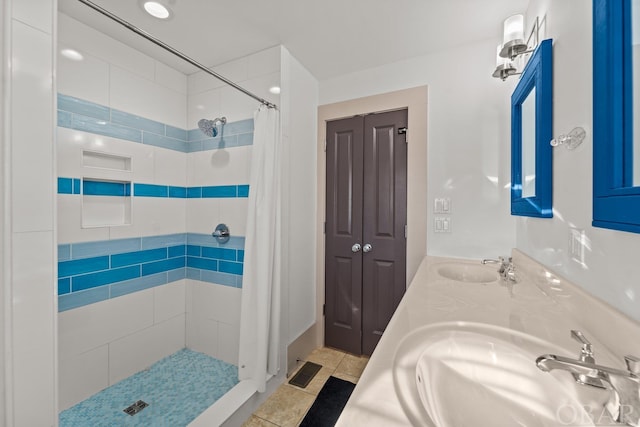 bathroom featuring tile patterned flooring, a shower stall, visible vents, and a sink