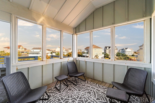 sunroom / solarium with lofted ceiling and a residential view