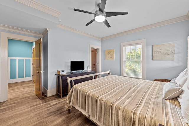 bedroom featuring ornamental molding, ceiling fan, and wood finished floors