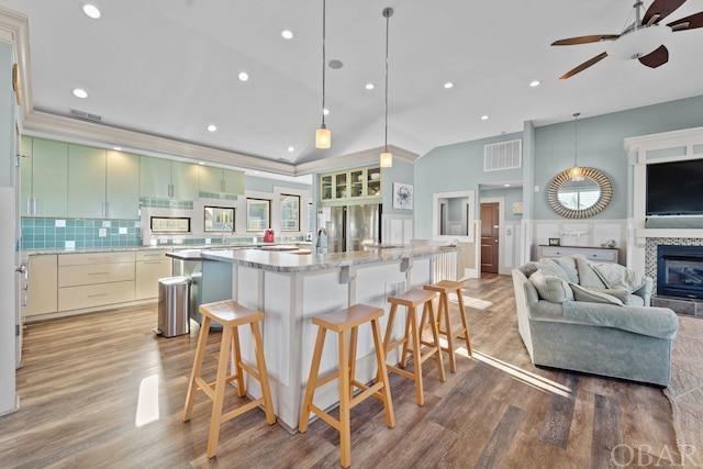 kitchen with open floor plan, modern cabinets, a kitchen island, and pendant lighting