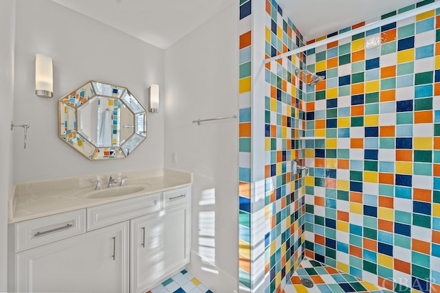 bathroom with a shower stall and vanity